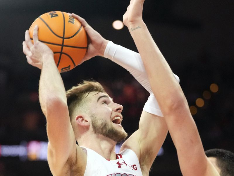 Feb 4, 2024; Madison, Wisconsin, USA; Wisconsin Badgers forward Tyler Wahl (5) scores against Purdue Boilermakers center Zach Edey (15) during the second half at the Kohl Center. Mandatory Credit: Kayla Wolf-USA TODAY Sports