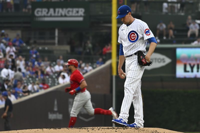 Jun 29, 2023; Chicago, Illinois, USA;  Chicago Cubs starting pitcher Kyle Hendricks (28) looks on as Philadelphia Phillies left fielder Kyle Schwarber (12) rounds the bases after hitting a home run during the first inning at Wrigley Field. Mandatory Credit: Matt Marton-USA TODAY Sports