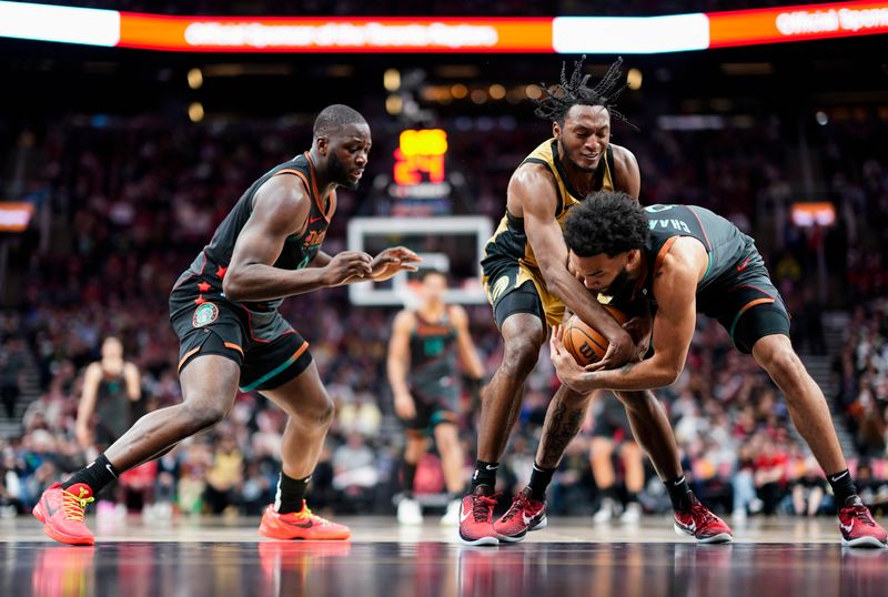 TORONTO, ON - APRIL 7: Immanuel Quickley #5 of the Toronto Raptors battles for the ball with Justin Champagnie #9 of the Washington Wizards during the second half at the Scotiabank Arena on April 7, 2024 in Toronto, Ontario, Canada. NOTE TO USER: User expressly acknowledges and agrees that, by downloading and/or using this Photograph, user is consenting to the terms and conditions of the Getty Images License Agreement. (Photo by Mark Blinch/Getty Images)