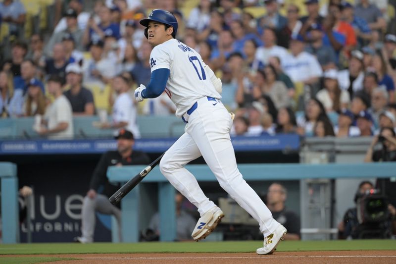 Jul 24, 2024; Los Angeles, California, USA;  Los Angeles Dodgers designated hitter Shohei Ohtani (17) hits a long fly ball for an out in the first inning against the San Francisco Giants at Dodger Stadium. Mandatory Credit: Jayne Kamin-Oncea-USA TODAY Sports