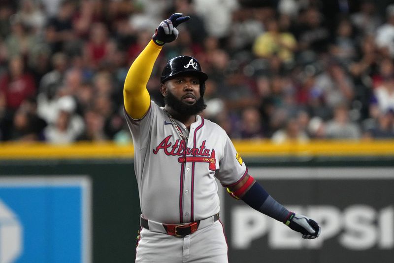 Apr 27, 2025; Phoenix, Arizona, USA; Atlanta Braves designated hitter Marcell Ozuna (20) reacts after hitting an RBI double against the Arizona Diamondbacks in the ninth inning at Chase Field. Mandatory Credit: Rick Scuteri-Imagn Images