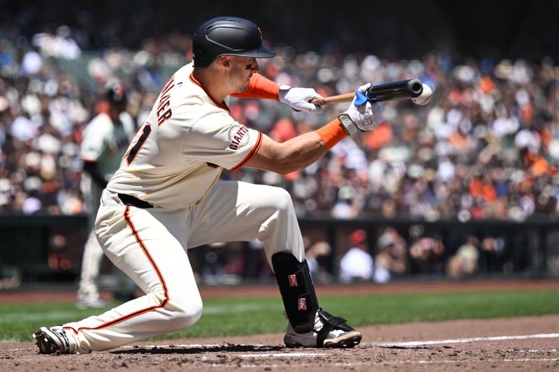 Jun 26, 2025; San Francisco, California, USA;  San Francisco Giants catcher Andrew Knizner (21) bunts against the Miami Marlins in the fourth inning at Oracle Park. Mandatory Credit: Eakin Howard-Imagn Images