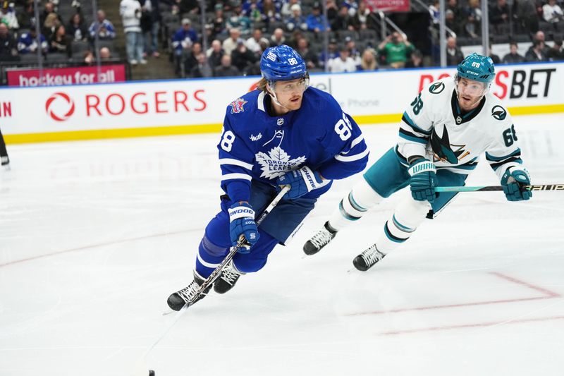 Jan 9, 2024; Toronto, Ontario, CAN; Toronto Maple Leafs right wing William Nylander (88) skates with the puck as San Jose Sharks center Mike Hoffman (68) gives chase during the second period at Scotiabank Arena. Mandatory Credit: Nick Turchiaro-USA TODAY Sports