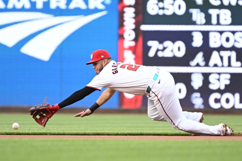 May 8, 2024; Washington, District of Columbia, USA; Washington Nationals second base Luis Garcia Jr. (2) dives to stop a ground ball against the Baltimore Orioles during the first inning at Nationals Park. Mandatory Credit: Rafael Suanes-USA TODAY Sports