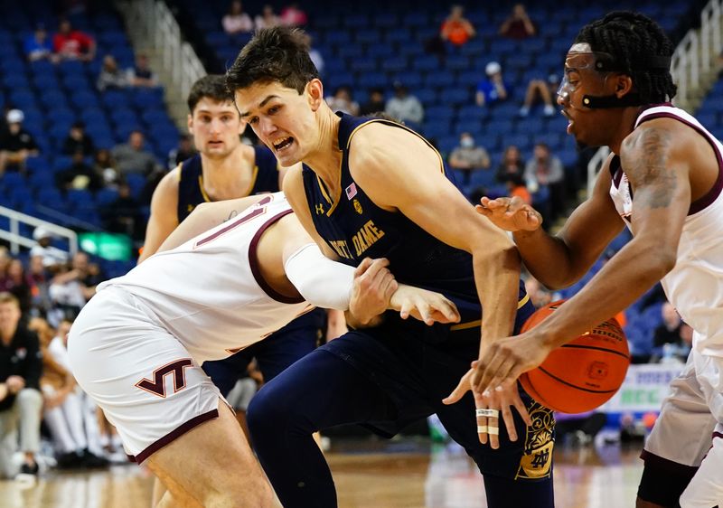 Mar 7, 2023; Greensboro, NC, USA; Notre Dame Fighting Irish guard Cormac Ryan (5) battles for a loose ball with Virginia Tech Hokies guard MJ Collins (2) during the second half of the first round of the ACC tournament at Greensboro Coliseum. Mandatory Credit: John David Mercer-USA TODAY Sports