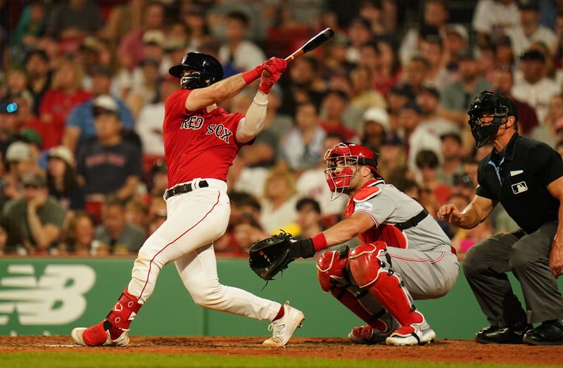 Jun 1, 2023; Boston, Massachusetts, USA; Boston Red Sox catcher Connor Wong (12) hits a two run home run against the Cincinnati Redsin the eighth inning at Fenway Park. Mandatory Credit: David Butler II-USA TODAY Sports