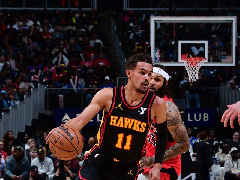 ATLANTA, GA - February 23:  Trae Young #11 of the Atlanta Hawks handles the ball during the game against the Toronto Raptors on February 23, 2024 at State Farm Arena in Atlanta, Georgia.  NOTE TO USER: User expressly acknowledges and agrees that, by downloading and/or using this Photograph, user is consenting to the terms and conditions of the Getty Images License Agreement. Mandatory Copyright Notice: Copyright 2024 NBAE (Photo by Scott Cunningham/NBAE via Getty Images)