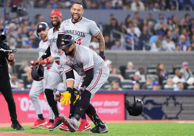 May 11, 2024; Toronto, Ontario, CAN; Minnesota Twins first base Carlos Santana (30) catches a sausage thrown out from the dugout after hitting a three run home run against the Toronto Blue Jays during the third inning at Rogers Centre. Mandatory Credit: Nick Turchiaro-USA TODAY Sports