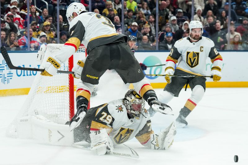 Dec 13, 2025; Columbus, Ohio, USA;  Vegas Golden Knights defenseman Brayden McNabb (3) leaps over goaltender Carter Hart (79) as he makes a save against the Columbus Blue Jackets in the second period at Nationwide Arena. Mandatory Credit: Aaron Doster-Imagn Images