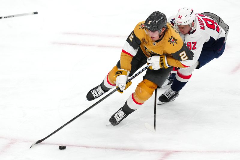 Dec 2, 2023; Las Vegas, Nevada, USA; Vegas Golden Knights defenseman Zach Whitecloud (2) skates ahead of Washington Capitals center Evgeny Kuznetsov (92) during the third period at T-Mobile Arena. Mandatory Credit: Stephen R. Sylvanie-USA TODAY Sports