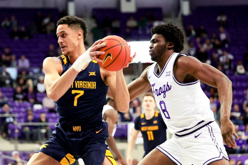 Feb 12, 2024; Fort Worth, Texas, USA;  West Virginia Mountaineers center Jesse Edwards (7) drives to the basket past TCU Horned Frogs center Ernest Udeh Jr. (8) during the second half at Ed and Rae Schollmaier Arena. Mandatory Credit: Kevin Jairaj-USA TODAY Sports