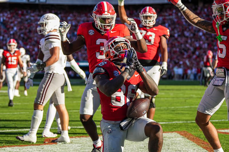 Oct 12, 2024; Athens, Georgia, USA; Georgia Bulldogs wide receiver Dillon Bell (86) reacts with teammates after catching a touchdown pass against the Mississippi State Bulldogs during the first half at Sanford Stadium. Mandatory Credit: Dale Zanine-Imagn Images