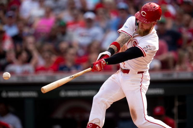 Jun 22, 2024; Cincinnati, Ohio, USA; Cincinnati Reds outfielder Jake Fraley (27) hits a base hit in the sixth inning of the MLB baseball game between the Cincinnati Reds and the Boston Red Sox at Great American Ball Park in Cincinnati on Saturday, June 22, 2024. Mandatory Credit: Albert Cesare-The Cincinnati Enquirer-USA TODAY Sports