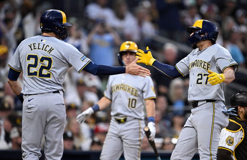 Jun 20, 2024; San Diego, California, USA; Milwaukee Brewers shortstop Willy Adames (27) celebrates with left fielder Christian Yelich (22) after hitting a two-run home run against the San Diego Padres during the fifth inning at Petco Park. Mandatory Credit: Orlando Ramirez-USA TODAY Sports