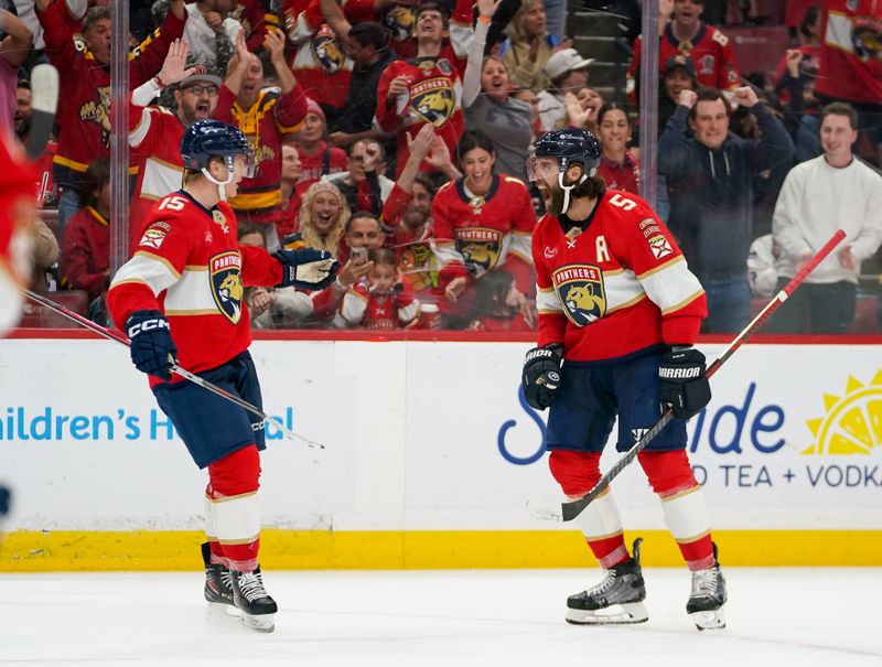Dec 29, 2025; Sunrise, Florida, USA; Florida Panthers defenseman Aaron Ekblad (5) celebrates his goal with  center Anton Lundell (15) against the Washington Capitals during the third period at Amerant Bank Arena. Mandatory Credit: Jeff Romance-Imagn Images