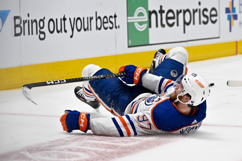 May 25, 2024; Dallas, Texas, USA; Edmonton Oilers center Connor McDavid (97) slides across the ice in the Dallas Stars zone during the first period in game two of the Western Conference Final of the 2024 Stanley Cup Playoffs at American Airlines Center. Mandatory Credit: Jerome Miron-USA TODAY Sports