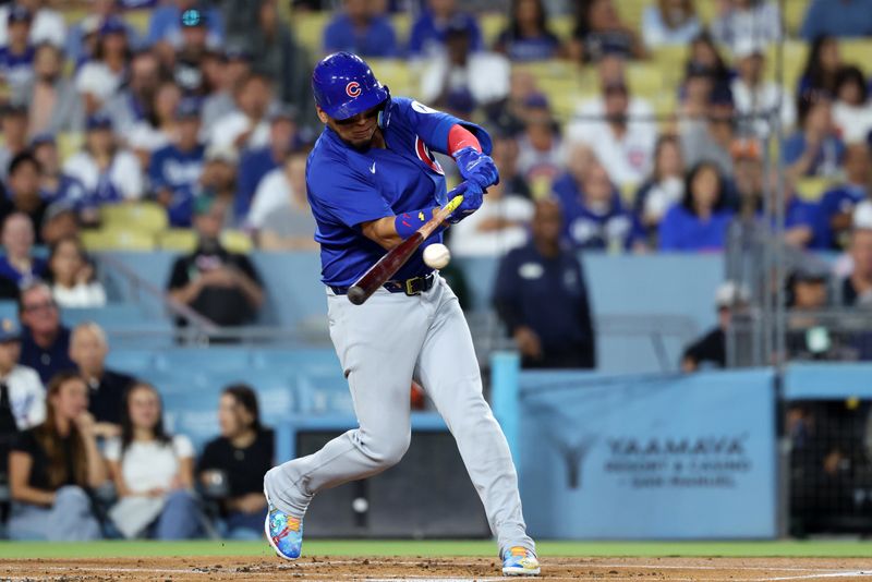 Sep 11, 2024; Los Angeles, California, USA;  Chicago Cubs third baseman Isaac Paredes (17) hits an RBI single during the first inning against the Los Angeles Dodgers at Dodger Stadium. Mandatory Credit: Kiyoshi Mio-Imagn Images