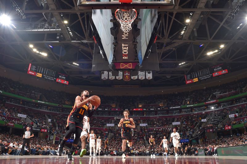 CLEVELAND, OH - NOVEMBER 27: Trae Young #11 of the Atlanta Hawks drives to the basket during the game against the Cleveland Cavaliers on November 27, 2024 at Rocket Mortgage FieldHouse in Cleveland, Ohio. NOTE TO USER: User expressly acknowledges and agrees that, by downloading and/or using this Photograph, user is consenting to the terms and conditions of the Getty Images License Agreement. Mandatory Copyright Notice: Copyright 2024 NBAE (Photo by David Liam Kyle/NBAE via Getty Images)