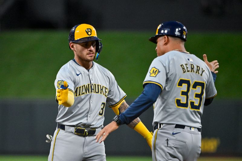 Aug 20, 2024; St. Louis, Missouri, USA;  Milwaukee Brewers third baseman Joey Ortiz (3) is congratulated by first base coach Quintin Berry (33) after hitting a one run single against the St. Louis Cardinals during the fifth inning at Busch Stadium. Mandatory Credit: Jeff Curry-USA TODAY Sports