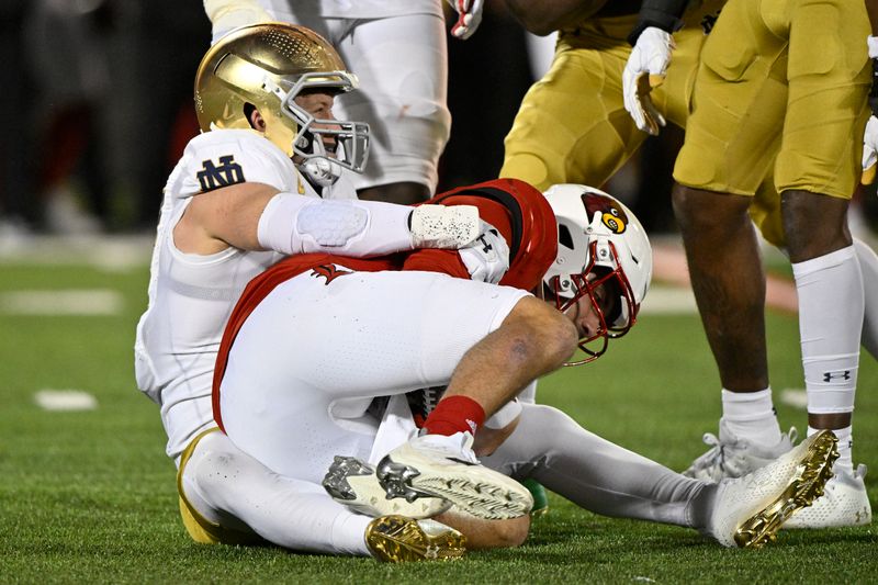 Oct 7, 2023; Louisville, Kentucky, USA; Notre Dame Fighting Irish linebacker JD Bertrand (27) smiles after sacking Louisville Cardinals quarterback Jack Plummer (13) during the first half at L&N Federal Credit Union Stadium. Mandatory Credit: Jamie Rhodes-USA TODAY Sports