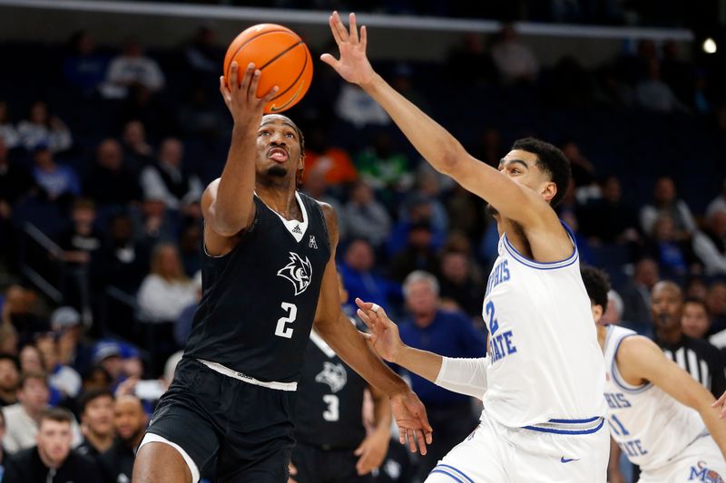 Jan 31, 2024; Memphis, Tennessee, USA; Rice Owls guard Mekhi Mason (2) drives to the basket as Memphis Tigers forward Nicholas Jourdain (2) defends during the second half at FedExForum. Mandatory Credit: Petre Thomas-USA TODAY Sports