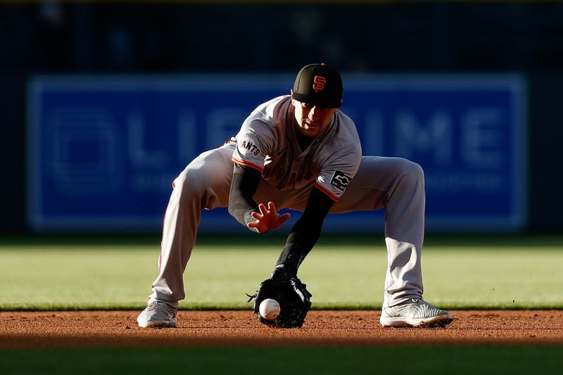 May 7, 2024; Denver, Colorado, USA; San Francisco Giants shortstop Nick Ahmed (16) fields the ball in the first inning against the Colorado Rockies at Coors Field. Mandatory Credit: Isaiah J. Downing-USA TODAY Sports