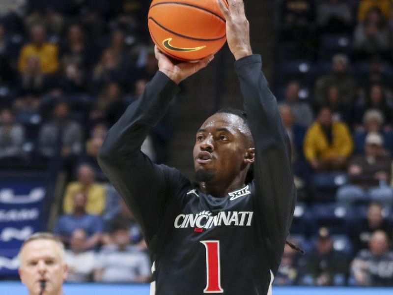 Jan 6, 2026; Morgantown, West Virginia, USA; Cincinnati Bearcats guard Day Day Thomas (1) shoots a three pointer during the first half against the West Virginia Mountaineers at Hope Coliseum. Mandatory Credit: Ben Queen-Imagn Images