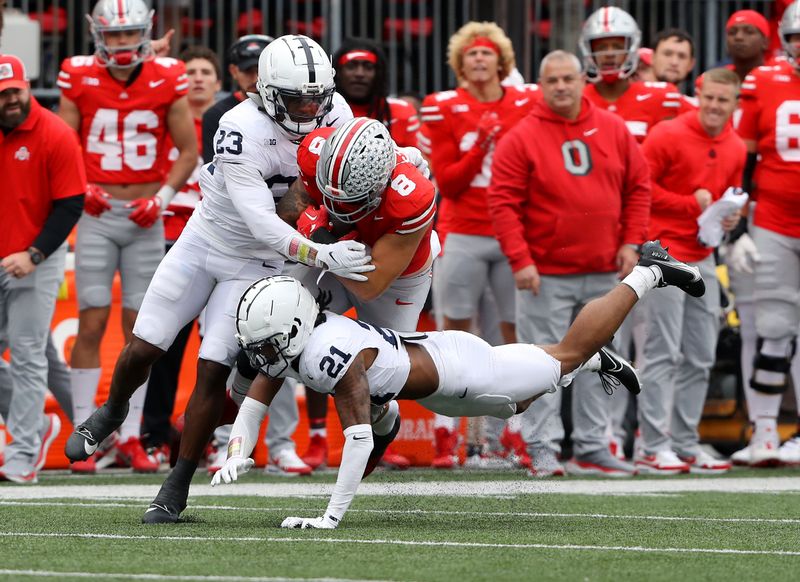 Oct 21, 2023; Columbus, Ohio, USA; Penn State Nittany Lions safety Kevin Winston Jr. (21) and linebacker Curtis Jacobs (23) tackle Ohio State Buckeyes tight end Cade Stover (8) during the third quarter at Ohio Stadium. Mandatory Credit: Joseph Maiorana-USA TODAY Sports