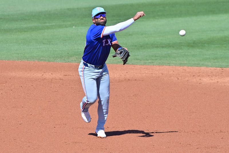 Mar 11, 2024; Tempe, Arizona, USA;  Texas Rangers shortstop Ezequiel Duran (20) throws to first base in the second inning against the Los Angeles Angels during a spring training game at Tempe Diablo Stadium. Mandatory Credit: Matt Kartozian-USA TODAY Sports