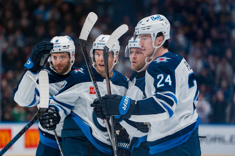 Mar 18, 2025; Vancouver, British Columbia, CAN; Winnipeg Jets defenseman Colin Miller (6) and forward Vladislav Namestnikov (7) and forward Nikolaj Ehlers (27) and defenseman Haydn Fleury (24) celebrate Ehlers’ goal against the Vancouver Canucks in the first period at Rogers Arena. Mandatory Credit: Bob Frid-Imagn Images