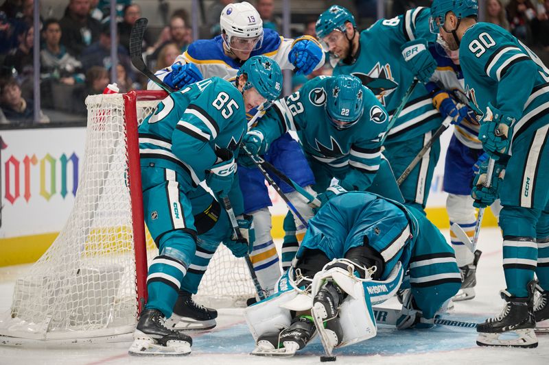 Jan 27, 2024; San Jose, California, USA; San Jose Sharks players defend a puck in the crease against Buffalo Sabres center Peyton Krebs (19) during the third period at SAP Center at San Jose. Mandatory Credit: Robert Edwards-USA TODAY Sports