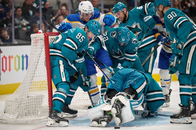 Jan 27, 2024; San Jose, California, USA; San Jose Sharks players defend a puck in the crease against Buffalo Sabres center Peyton Krebs (19) during the third period at SAP Center at San Jose. Mandatory Credit: Robert Edwards-USA TODAY Sports