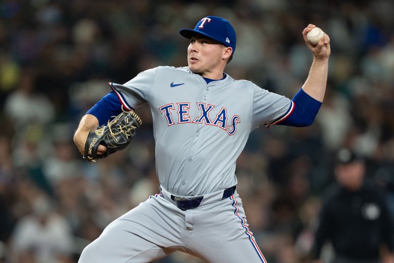 Sep 13, 2024; Seattle, Washington, USA;  Texas Rangers reliever Walter Pennington (52) delivers a pitch during the fifth inning against the Seattle Mariners at T-Mobile Park. Mandatory Credit: Stephen Brashear-Imagn Images