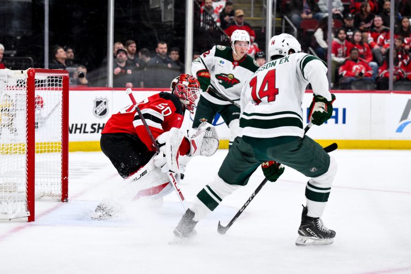 Oct 22, 2025; Newark, New Jersey, USA; New Jersey Devils goaltender Nico Daws (50) defends the net against the Minnesota Wild during the first period at Prudential Center. Mandatory Credit: John Jones-Imagn Images