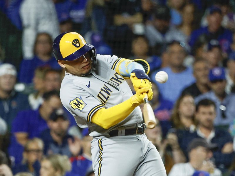 Aug 29, 2023; Chicago, Illinois, USA; Milwaukee Brewers catcher William Contreras (24) singles against the Chicago Cubs during the third inning at Wrigley Field. Mandatory Credit: Kamil Krzaczynski-USA TODAY Sports