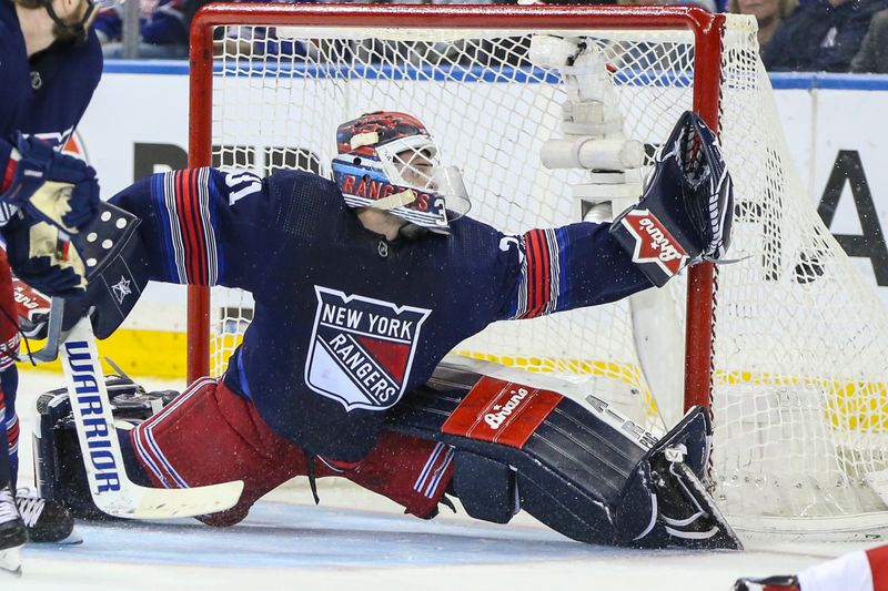 Apr 3, 2024; New York, New York, USA; The puck slides past New York Rangers goaltender Igor Shesterkin (31) in the second period against the New Jersey Devils at Madison Square Garden. Mandatory Credit: Wendell Cruz-USA TODAY Sports