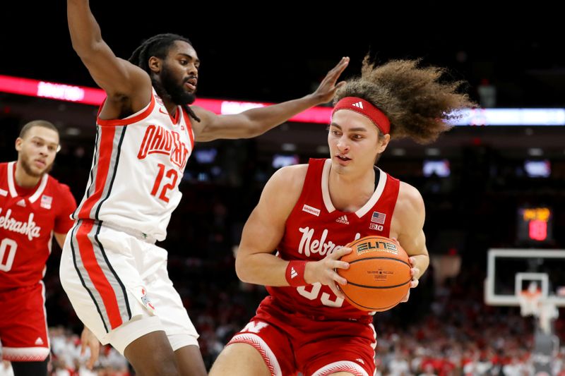 Feb 29, 2024; Columbus, Ohio, USA;  Nebraska Cornhuskers forward Josiah Allick (53) moves the ball as Ohio State Buckeyes guard Evan Mahaffey (12) defends during the first half at Value City Arena. Mandatory Credit: Joseph Maiorana-USA TODAY Sports