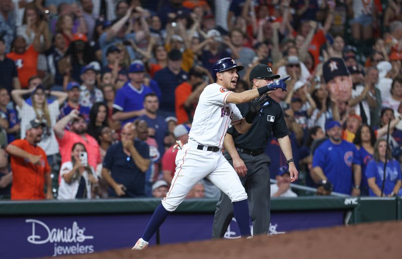 May 17, 2023; Houston, Texas, USA; Houston Astros second baseman Mauricio Dubon (14) points to shortstop Jeremy Pena (not pictured) after Pena hits a double during the ninth inning against the Chicago Cubs at Minute Maid Park. Mandatory Credit: Troy Taormina-USA TODAY Sports