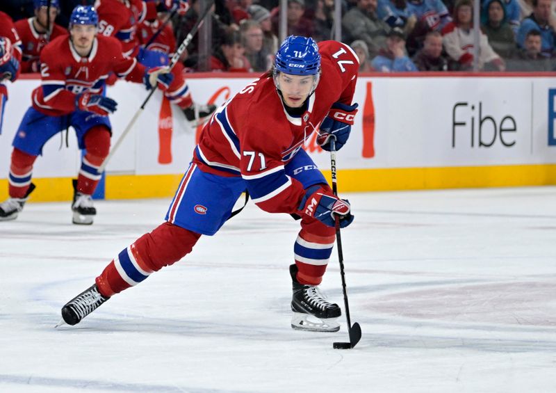 Feb 21, 2024; Montreal, Quebec, CAN; Montreal Canadiens forward Jake Evans (71) plays the puck during the third period of the game against the Buffalo Sabres at the Bell Centre. Mandatory Credit: Eric Bolte-USA TODAY Sports