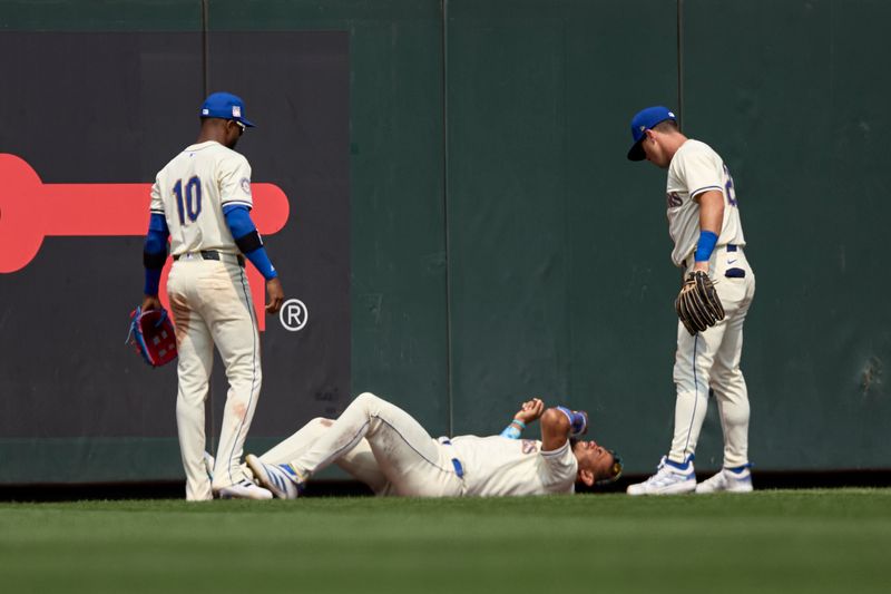 Jul 21, 2024; Seattle, Washington, USA; Seattle Mariners outfielders Victor Robles and Dylan Moore check on center fielder Julio Rodríguez (44) after he was injured during the sixth inning at T-Mobile Park. Mandatory Credit: John Froschauer-USA TODAY Sports