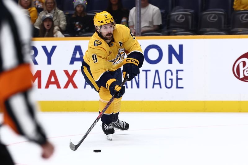 Oct 26, 2024; Nashville, Tennessee, USA; Nashville Predators left wing Filip Forsberg (9) shoots the puck in the first period against the Columbus Blue Jackets at Bridgestone Arena. Mandatory Credit: Casey Gower-Imagn Images