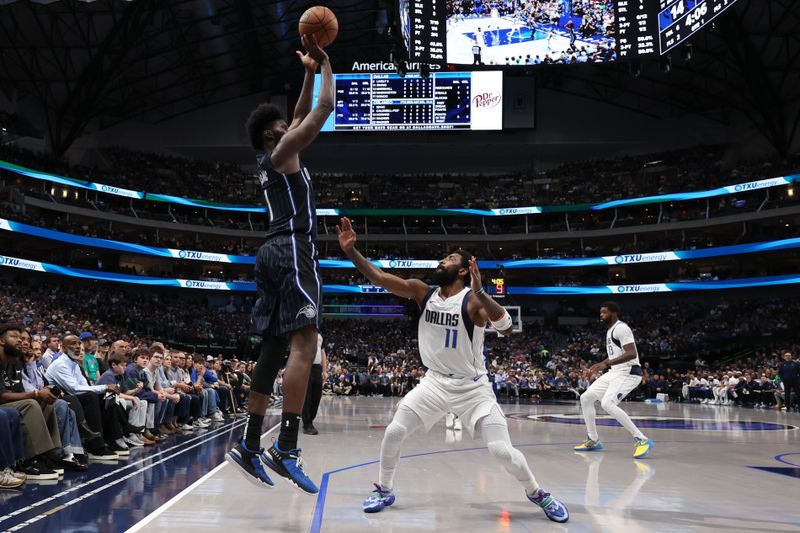 DALLAS, TEXAS - NOVEMBER 03: Jonathan Isaac #1 of the Orlando Magic shoots over Kyrie Irving #11 of the Dallas Mavericks during the first half at American Airlines Center on November 03, 2024 in Dallas, Texas. NOTE TO USER: User expressly acknowledges and agrees that, by downloading and or using this photograph, User is consenting to the terms and conditions of the Getty Images License Agreement. (Photo by Sam Hodde/Getty Images)