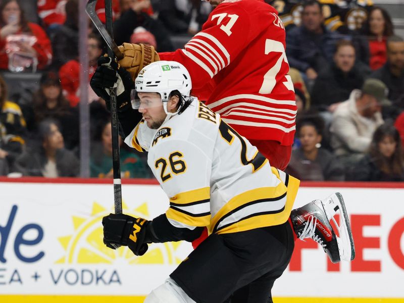 Dec 2, 2025; Detroit, Michigan, USA;  Detroit Red Wings center Dylan Larkin (71) leaps up next to Boston Bruins defenseman Andrew Peeke (26) in the second period at Little Caesars Arena. Mandatory Credit: Rick Osentoski-Imagn Images