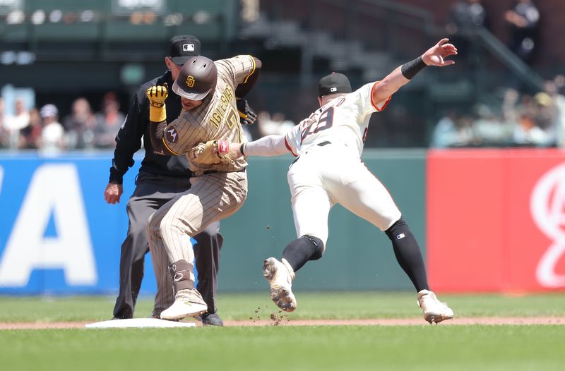 Jun 5, 2025; San Francisco, California, USA; San Francisco Giants second baseman Tyler Fitzgerald (49) makes a tag against San Diego Padres shortstop Jose Iglesias (7) for an out during the seventh inning at Oracle Park. Mandatory Credit: Kelley L Cox-Imagn Images