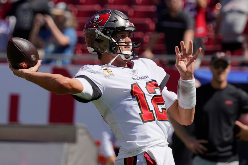 Tampa Bay Buccaneers quarterback Tom Brady warms up before the first half of an NFL football game between the Tampa Bay Buccaneers and the Atlanta Falcons Sunday, Oct. 9, 2022, in Tampa, Fla. (AP Photo/Chris O'Meara)