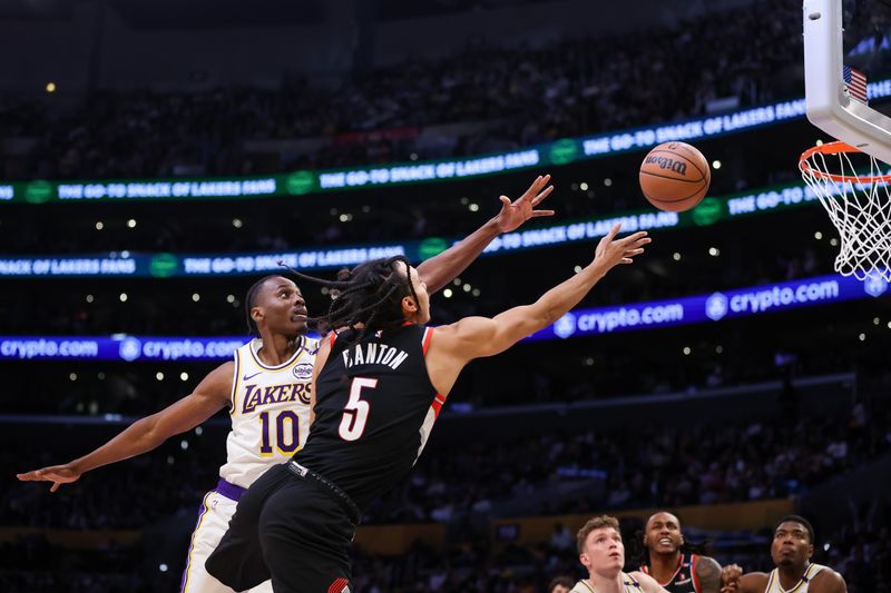 LOS ANGELES, CALIFORNIA - DECEMBER 08: Dalano Banton #5 of the Portland Trail Blazers drives to the basket defended by Christian Koloko #10 of the Los Angeles Lakers in the first half at Crypto.com Arena on December 08, 2024 in Los Angeles, California. NOTE TO USER: User expressly acknowledges and agrees that, by downloading and or using this Photograph, user is consenting to the terms and conditions of the Getty Images License Agreement. (Photo by Meg Oliphant/Getty Images)