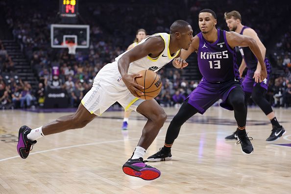 SACRAMENTO, CALIFORNIA - DECEMBER 16: Kris Dunn #11 of the Utah Jazz drives to the basket against Keegan Murray #13 of the Sacramento Kings in the first quarter at Golden 1 Center on December 16, 2023 in Sacramento, California. NOTE TO USER: User expressly acknowledges and agrees that, by downloading and or using this photograph, User is consenting to the terms and conditions of the Getty Images License Agreement. (Photo by Lachlan Cunningham/Getty Images)