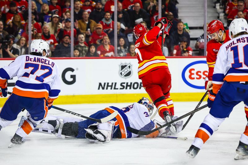 Jan 17, 2026; Calgary, Alberta, CAN; New York Islanders goaltender David Rittich (33) makes a save against Calgary Flames center Yegor Sharangovich (17) during the second period at Scotiabank Saddledome. Mandatory Credit: Sergei Belski-Imagn Images