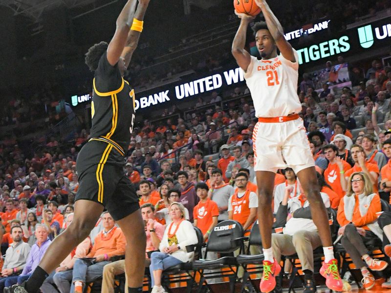 Feb 27, 2024; Clemson, South Carolina, USA;  Clemson sophomore forward Chauncey Wiggins (21) takes a shot near Pitt forward Zack Austin (55) during the first half at Littlejohn Coliseum. Mandatory Credit: Ken Ruinard-USA TODAY Sports