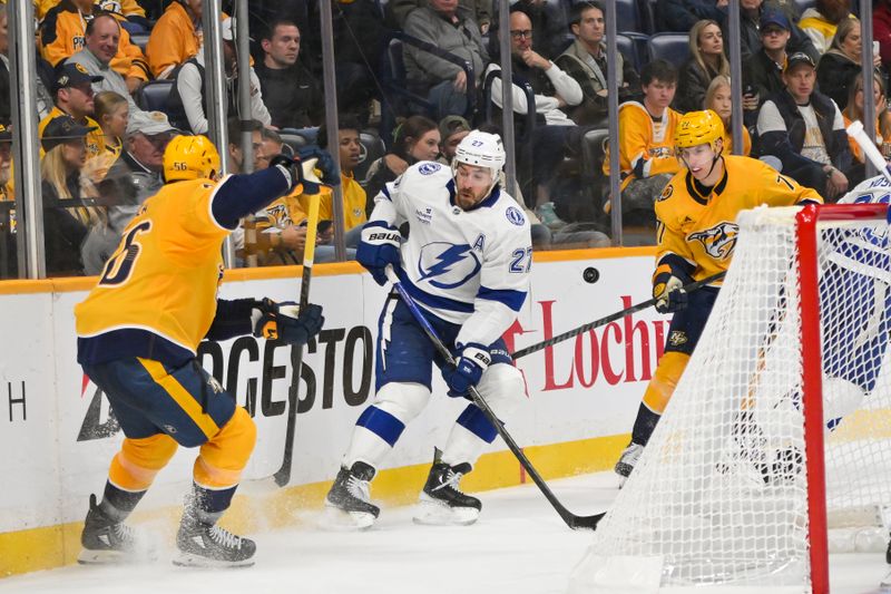Oct 28, 2025; Nashville, Tennessee, USA;  Nashville Predators left wing Erik Haula (56) and right wing Matthew Wood (71) fight for the puck with Tampa Bay Lightning defenseman Ryan McDonagh (27) during the third period at Bridgestone Arena. Mandatory Credit: Steve Roberts-Imagn Images